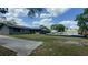 Backyard features a swimming pool, lush lawn, and mature trees, offering privacy at 434 Diamond Acres Rd, Davenport, FL 33837