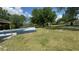 Large backyard with a pool, well maintained grass, and gazebo in the far corner at 434 Diamond Acres Rd, Davenport, FL 33837