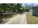 Long driveway leads to a basketball hoop and a well-maintained yard with mature trees at 434 Diamond Acres Rd, Davenport, FL 33837