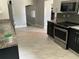 Open kitchen layout features stainless appliances, granite countertops and tile flooring at 434 Diamond Acres Rd, Davenport, FL 33837