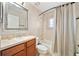 Well-lit bathroom features a shower-tub combo, tile surround, and a framed mirror over the vanity at 510 N Leavitt Ave, Orange City, FL 32763