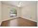 Cozy bedroom featuring wood floors, a large window, and ample natural light at 510 N Leavitt Ave, Orange City, FL 32763