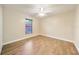 This bright bedroom offers a ceiling fan and wood look flooring at 510 N Leavitt Ave, Orange City, FL 32763