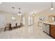 Bright dining area with elegant chandelier, decorative mirror and views of the front yard at 510 N Leavitt Ave, Orange City, FL 32763