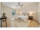 Serene main bedroom with wood-look floors, a ceiling fan, and soft, neutral decor at 510 N Leavitt Ave, Orange City, FL 32763