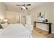 Spacious main bedroom with high ceilings, decorative art, and access to the en-suite bathroom at 510 N Leavitt Ave, Orange City, FL 32763