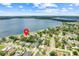 Aerial view showcasing the neighborhood and highlighting the home's proximity to the lake at 5224 Saint Regis Pl, Belle Isle, FL 32812