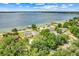 Aerial view of the bright yellow two-story home located waterfront property at 5224 Saint Regis Pl, Belle Isle, FL 32812