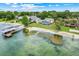 An aerial view reveals the waterfront estate with private beach, dock, and sparkling pool at 5224 Saint Regis Pl, Belle Isle, FL 32812