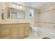 Well-lit bathroom with vanity, large mirror, tub and shower combo with tiled walls at 5224 Saint Regis Pl, Belle Isle, FL 32812