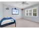 Cozy bedroom with a single bed, plantation shutters, and nautical themed wall decor at 5224 Saint Regis Pl, Belle Isle, FL 32812