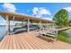 The covered boat dock provides a relaxing waterfront space with lounge chairs and boat lift at 5224 Saint Regis Pl, Belle Isle, FL 32812