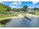 Scenic view of a boat ramp and dock, with a grassy park area nearby, leading to a serene lake at 5224 Saint Regis Pl, Belle Isle, FL 32812