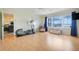 Bright bonus room featuring wood floors, an elliptical machine, and large windows with lovely lake views at 5224 Saint Regis Pl, Belle Isle, FL 32812