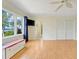 Bright bonus room featuring wood floors, large windows, and lake views at 5224 Saint Regis Pl, Belle Isle, FL 32812