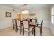Formal dining room featuring a modern chandelier, wainscoting, and seating for eight, perfect for Gathering gatherings at 5224 Saint Regis Pl, Belle Isle, FL 32812