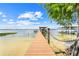A private wooden dock extends into the clear water, inviting boating and waterfront living at 5224 Saint Regis Pl, Belle Isle, FL 32812