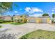 Bright yellow two-story home with a spacious three-car garage and large driveway at 5224 Saint Regis Pl, Belle Isle, FL 32812