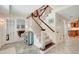 Home foyer with staircase and large decorative mirror with doorway leading to game room at 5224 Saint Regis Pl, Belle Isle, FL 32812