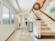 Home foyer with staircase and decorative mirror leading to a spacious game room at 5224 Saint Regis Pl, Belle Isle, FL 32812