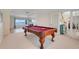Spacious game room featuring a pool table, open layout, and access to the main living areas of the home at 5224 Saint Regis Pl, Belle Isle, FL 32812