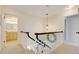 Upstairs hallway features carpet, a decorative mirror, and access to the bathroom and additional rooms at 5224 Saint Regis Pl, Belle Isle, FL 32812