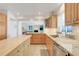 The kitchen features stainless appliances, wood cabinets, granite countertops, and a center island at 5224 Saint Regis Pl, Belle Isle, FL 32812