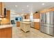 Spacious kitchen featuring stainless steel appliances, a center island, and tile flooring, perfect for culinary enthusiasts at 5224 Saint Regis Pl, Belle Isle, FL 32812