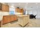 Bright kitchen with stainless appliances, wood cabinets, center island, and water views from the breakfast nook at 5224 Saint Regis Pl, Belle Isle, FL 32812