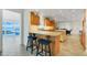 Kitchen with granite countertops, stainless steel appliances, island seating, and access to a waterfront view at 5224 Saint Regis Pl, Belle Isle, FL 32812