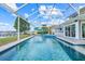 Screened in pool with lake view, lush greenery, patio furniture, and access to the house at 5224 Saint Regis Pl, Belle Isle, FL 32812