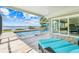 Screened pool with lake view, patio furniture, and sliding glass door to the house at 5224 Saint Regis Pl, Belle Isle, FL 32812
