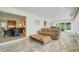 The sunroom boasts water views and has a wicker table, access to kitchen and has wood-look floors at 5224 Saint Regis Pl, Belle Isle, FL 32812