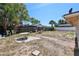 Large backyard with mature trees and partial fence is an ideal outdoor space to develop your dreams at 525 E Foothill Way, Casselberry, FL 32707