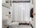 Classic bathroom with toilet and striped shower curtain with polka dots at 525 E Foothill Way, Casselberry, FL 32707