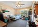 Comfortable bedroom with window, ceiling fan, and neutral carpeting at 525 E Foothill Way, Casselberry, FL 32707