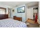 Bedroom featuring hardwood floors, TV, and access to a bathroom or closet at 525 E Foothill Way, Casselberry, FL 32707