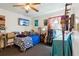 Cozy bedroom featuring blue bedding, guitar cases, and a ceiling fan for added comfort at 525 E Foothill Way, Casselberry, FL 32707