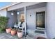 Inviting front porch with seating, potted plants, and decorative hanging planters at 525 E Foothill Way, Casselberry, FL 32707