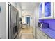 Galley kitchen with stainless steel appliances and white cabinetry offers a modern and efficient design at 525 E Foothill Way, Casselberry, FL 32707