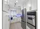 Updated kitchen with stainless steel appliances and white cabinetry provides an efficient cooking space at 525 E Foothill Way, Casselberry, FL 32707