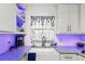 Close-up of kitchen farmhouse sink with granite countertops and white subway tile backsplash at 525 E Foothill Way, Casselberry, FL 32707