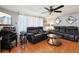 Cozy living room featuring comfortable leather seating and a ceiling fan at 525 E Foothill Way, Casselberry, FL 32707