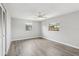 Light-filled bedroom with wood-look floors, ceiling fan, and two windows at 525 Legume Dr, Port Orange, FL 32127