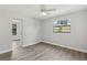 Bedroom with ceiling fan and view of the backyard, showcasing a bright and airy space at 525 Legume Dr, Port Orange, FL 32127