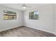 Bright bedroom featuring vinyl floors, neutral walls, and two windows at 525 Legume Dr, Port Orange, FL 32127