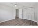 Bedroom featuring a ceiling fan, closet with white louvered doors, and wood-look flooring at 525 Legume Dr, Port Orange, FL 32127