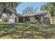 Charming home with well-maintained lawn, tasteful landscaping, an attached garage, and stylish exterior at 525 Legume Dr, Port Orange, FL 32127