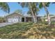 Charming single-story home with well-maintained lawn and mature trees providing shade at 525 Legume Dr, Port Orange, FL 32127