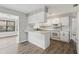 Modern white kitchen featuring bar seating, white subway tiles, and stainless appliances at 525 Legume Dr, Port Orange, FL 32127